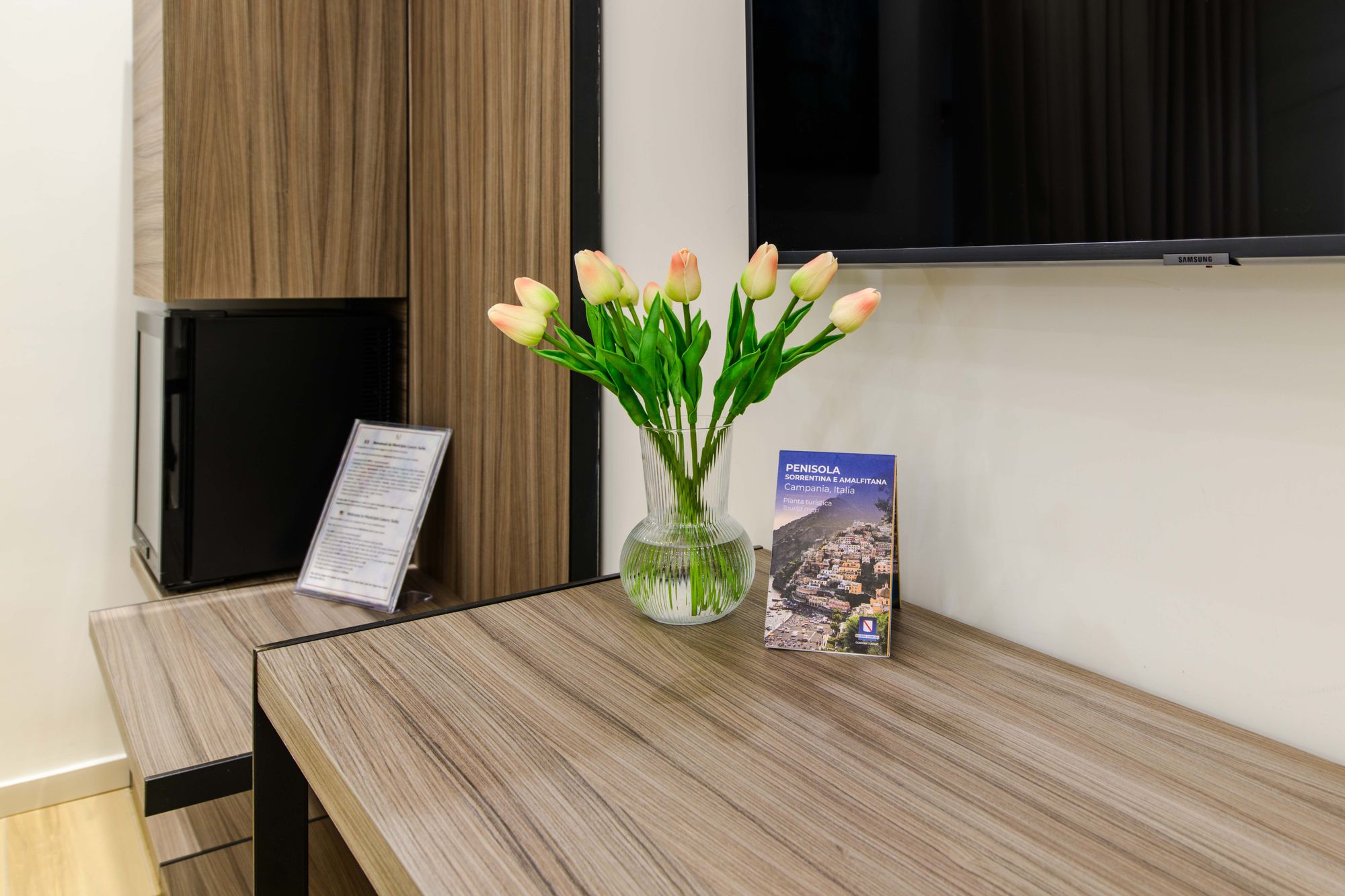 Scrivania con vaso di tulipani e guida turistica di Napoli, camera Piazza Municipio
